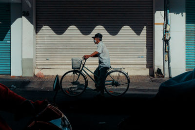 Side view of man riding bicycle