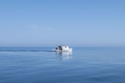 Boat sailing in sea against sky