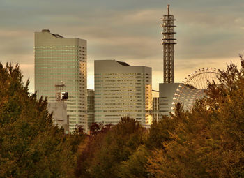 Buildings in city against sky during sunset