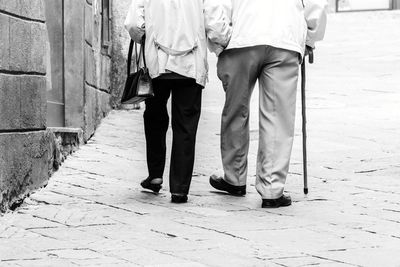 Low section of people walking on footpath