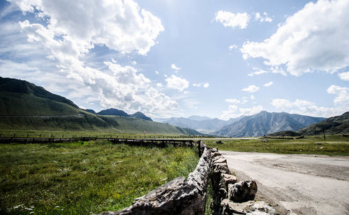 Panoramic view of road leading towards mountains against sky