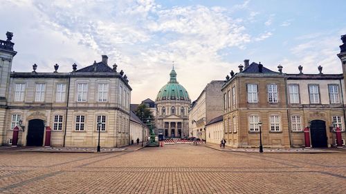 Buildings in city against sky