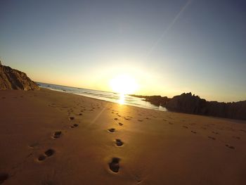 Scenic view of beach at sunset