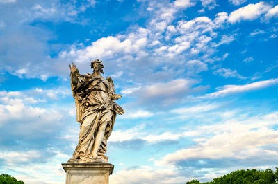 Low angle view of statue against cloudy sky