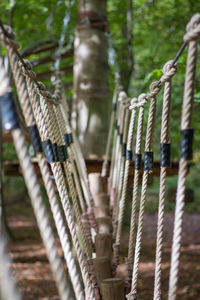 Close-up of rope tied up on metal fence