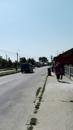 Cars on road against clear sky