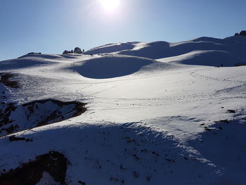 Scenic view of frozen mountain against clear sky