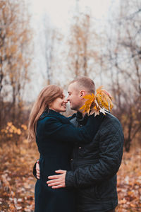 Young couple standing on land during autumn