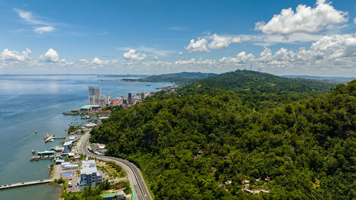 High angle view of townscape by sea against sky