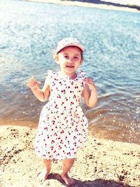 Cute girl standing on beach