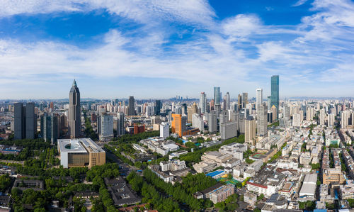 Aerial view of modern buildings in city against sky
