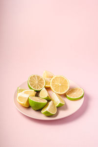 Fruits in plate against white background