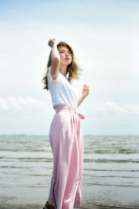 Side view of woman standing at beach