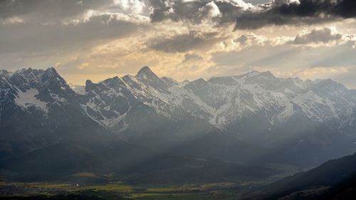 Scenic view of snowcapped mountains against sky during sunset