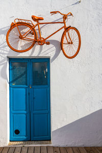 Bicycle against blue door