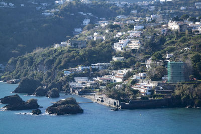 High angle view of townscape by sea