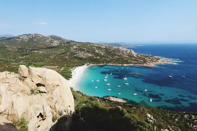 High angel view of sailboats anchored in sea against sky