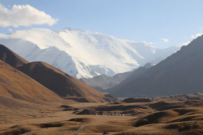 Scenic view of snowcapped mountains against sky