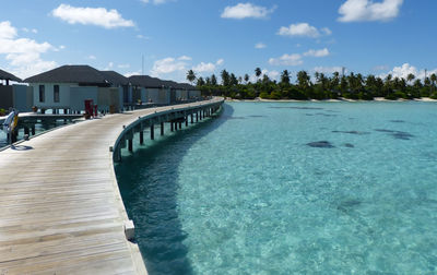 View of swimming pool by sea against sky