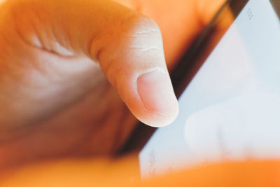 Close-up of hand using digital tablet