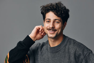 Portrait of young man against white background