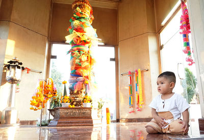 Cute boy sitting at temple
