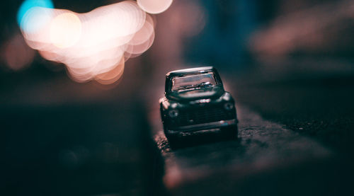 Close-up of person holding smart phone on table