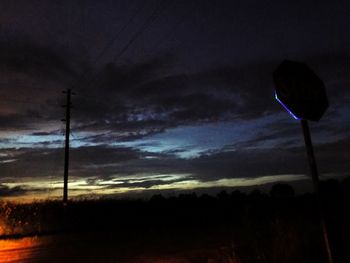 Scenic view of illuminated street light against sky at dusk