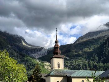 Low angle view of building and mountains against sky