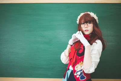 Portrait of beautiful young woman standing outdoors