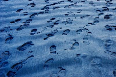 Full frame shot of footprints in sand