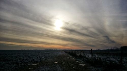 Scenic view of beach against sky during sunset