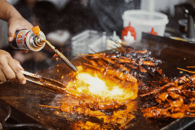 Midsection of man preparing food