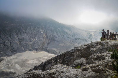 A young man standing on the crater rim, at mount tangkuban perahu, bandung, west java, indonesia