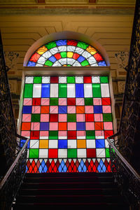 Low angle view of multi colored glass building