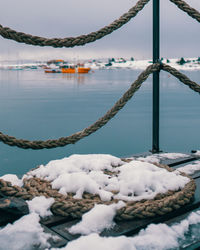 Frozen lake against sky during winter