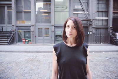 Beautiful woman standing against building