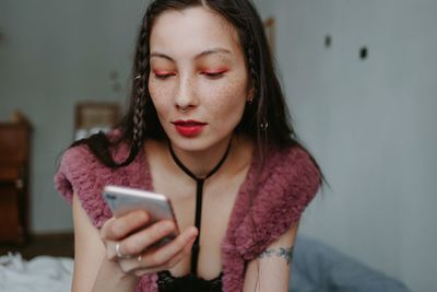 Woman with smartphone at home