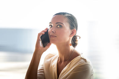 Portrait of young woman using mobile phone