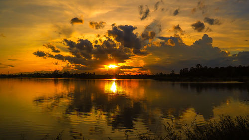 Scenic view of lake against orange sky