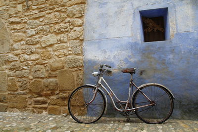 Bicycle leaning against wall