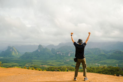 New normal outdoor lifestyle of man during travel on mountain with happy and successful feeling