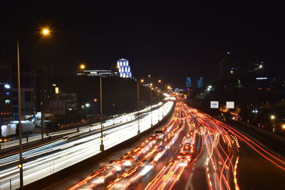 Light trails on road in city at night