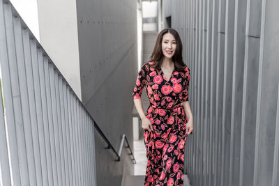 Portrait of woman standing against wall