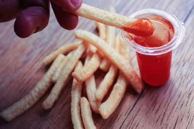 High angle view of hand holding food on table