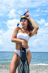 Full length of woman on beach against sky