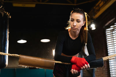 Portrait of young woman exercising in workshop
