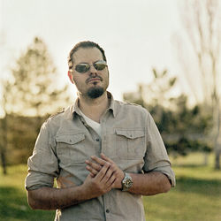 Man wearing sunglasses while standing against sky