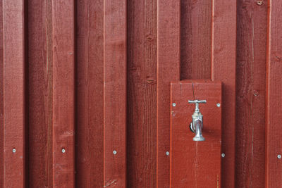 Faucet on brown wall