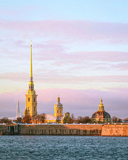 View of illuminated buildings against sky in city